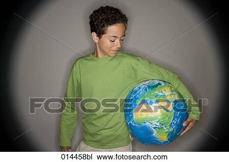 boy wearing green holding inflatable globe View Large Photo Image Stock Image - boy wearing green holding inflatable globe. Fotosearch