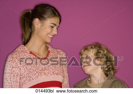 brother and sister smiling at each other View Large Photo Image Stock Image - brother and sister smiling at each other. Fotosearch