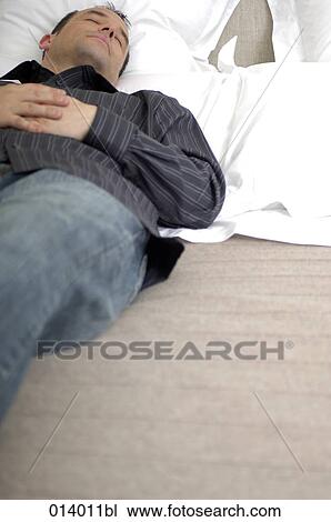 casually dressed man sleeping View Large Photo Image Stock Image - casually dressed man sleeping. Fotosearch