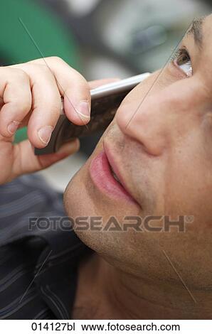 close-up of face of young man with cellphone View Large Photo Image Stock Image - close-up of face of young man with cellphone. Fotosearch