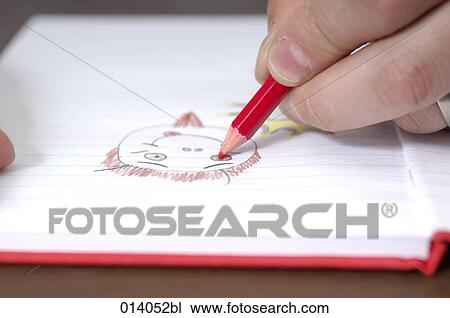 Stock Image - close-up of male hand making drawing in book. Fotosearch