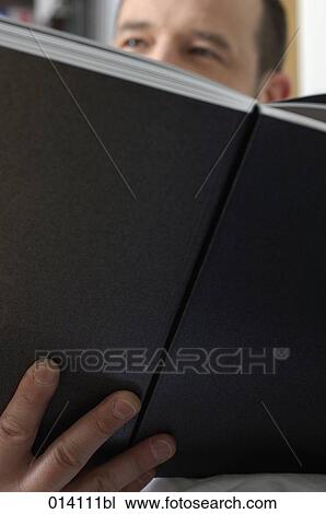 close-up of man holding book View Large Photo Image Stock Image - close-up of man holding book. Fotosearch