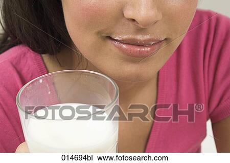 close-up of young woman holding glass of milk View Large Photo Image Stock Image - close-up of young woman holding glass of milk. Fotosearch