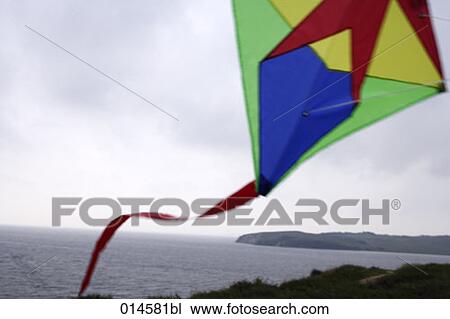 colourful kite flying in wind at seaside View Large Photo Image Stock Image - colourful kite flying in wind at seaside. Fotosearch