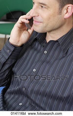 content young man listening to mobile phone View Large Photo Image Stock Image - content young man listening to mobile phone. Fotosearch