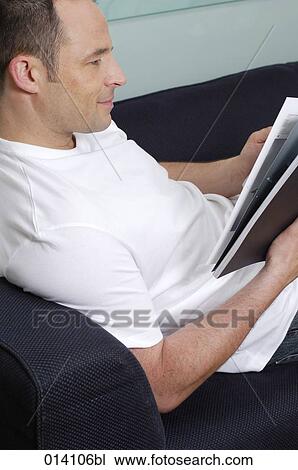 content young man reading on sofa View Large Photo Image Stock Image - content young man reading on sofa. Fotosearch