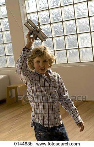 curly haired boy playing with toy plane View Large Photo Image Stock Image - curly haired boy playing with toy plane. Fotosearch