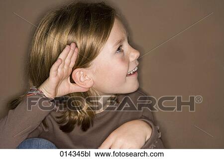 Stock Image - girl putting hand on ear. Fotosearch