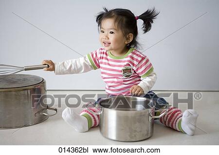 girl sitting on floor happily playing with saucepans View Large Photo Image Stock Image - girl sitting on floor happily playing with saucepans. Fotosearch
