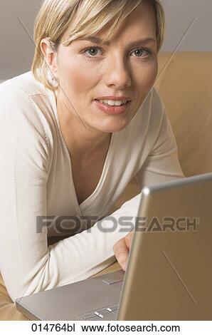 headshot of blonde woman working with laptop computer View Large Photo Image Stock Image - headshot of blonde woman working with laptop computer. Fotosearch