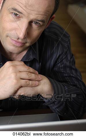 Stock Image - headshot of man with notebook computer. Fotosearch