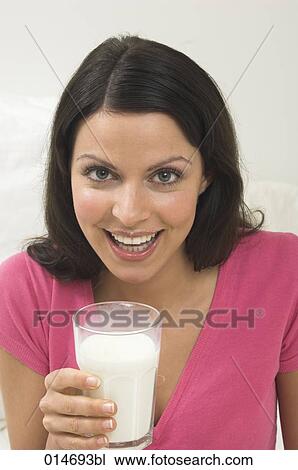 headshot of smiling young woman drinking glass of milk View Large Photo Image Stock Image - headshot of smiling young woman drinking glass of milk. Fotosearch