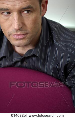 headshot of young businessman looking suspicious View Large Photo Image Stock Image - headshot of young businessman looking suspicious. Fotosearch