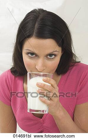 headshot of young woman drinking glass of milk View Large Photo Image Stock Image - headshot of young woman drinking glass of milk. Fotosearch