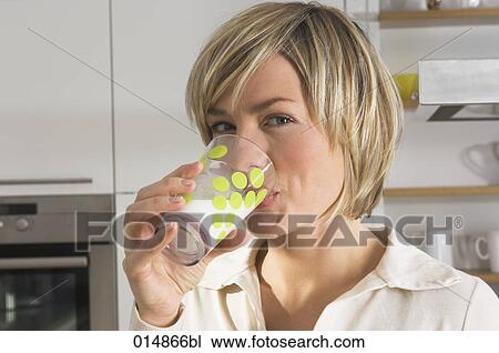 headshot of young woman drinking glass of milk in kitchen View Large Photo Image Stock Image - headshot of young woman drinking glass of milk in kitchen. Fotosearch