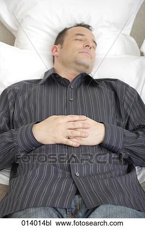 high angle view of man dozing in his bed View Large Photo Image Stock Image - high angle view of man dozing in his bed. Fotosearch
