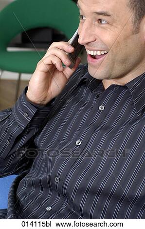 laughing young man talking on mobile phone View Large Photo Image Stock Image - laughing young man talking on mobile phone. Fotosearch