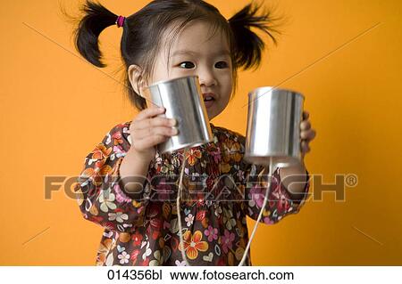 little asian girl holding string telephone View Large Photo Image Stock Image - little asian girl holding string telephone. Fotosearch