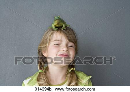 little girl playing with toy frog on her head View Large Photo Image Stock Image - little girl playing with toy frog on her head. Fotosearch