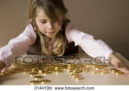 little girl with many gold coins on table View Large Photo Image Stock Image - little girl with many gold coins on table. Fotosearch