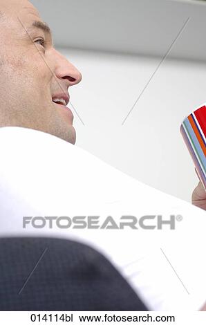 low angle portrait of young man relaxing with coffee cup on sofa View Large Photo Image Stock Image - low angle portrait of young man relaxing with coffee cup on sofa. Fotosearch