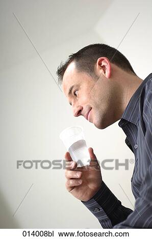 low angle view of man with plastic cup View Large Photo Image Stock Image - low angle view of man with plastic cup. Fotosearch