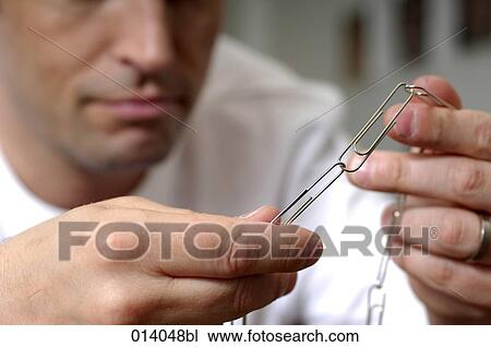 man assembling paper clips to chain View Large Photo Image Stock Image - man assembling paper clips to chain. Fotosearch