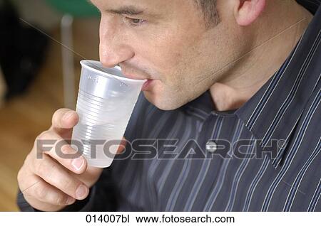 man having some water from plastic cup View Large Photo Image Stock Image - man having some water from plastic cup. Fotosearch