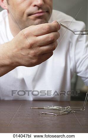 man making chain out of paper clips View Large Photo Image Stock Image - man making chain out of paper clips. Fotosearch