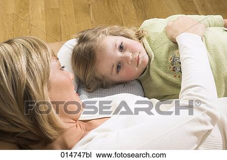 mother and little daughter lying on sofa together View Large Photo Image Stock Image - mother and little daughter lying on sofa together. Fotosearch