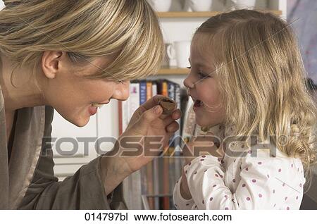 mother feeding her little daughter with sweets View Large Photo Image Stock Image - mother feeding her little daughter with sweets. Fotosearch