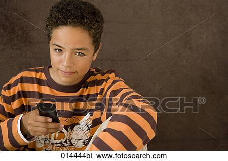 portrait of African American boy holding mobile phone View Large Photo Image Stock Image - portrait of African American boy holding mobile phone. Fotosearch