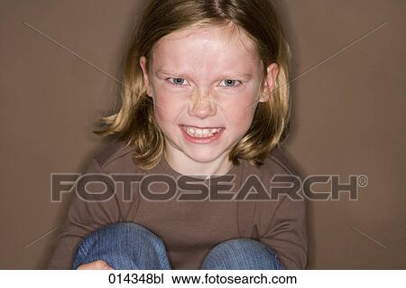 Stock Image - portrait of angry young girl. Fotosearch
