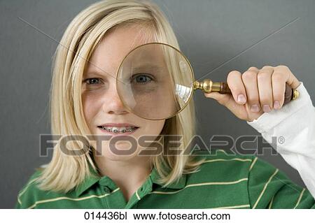 Stock Image - portrait of blonde boy holding magnifying glass. Fotosearch