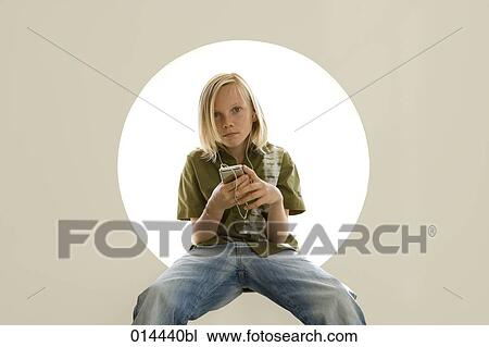 portrait of blonde boy sitting in circular hole with ipod View Large Photo Image Stock Image - portrait of blonde boy sitting in circular hole with ipod. Fotosearch
