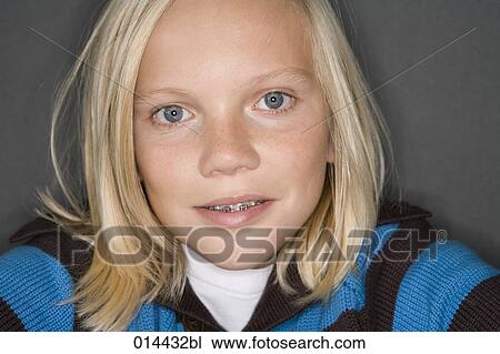 Stock Image - portrait of blonde boy wearing tooth braces. Fotosearch