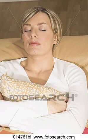 portrait of blonde woman dozing on sofa View Large Photo Image Stock Image - portrait of blonde woman dozing on sofa. Fotosearch