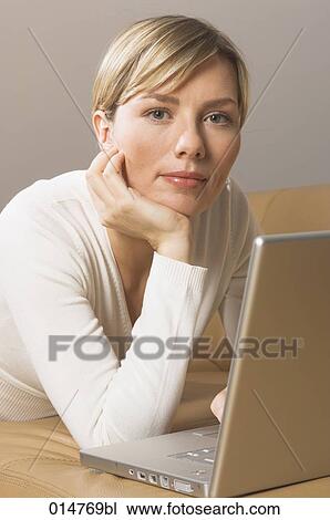 portrait of blonde woman on sofa with notebook computer View Large Photo Image Stock Image - portrait of blonde woman on sofa with notebook computer. Fotosearch
