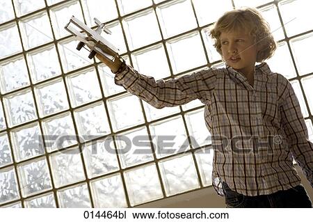 portrait of boy playing with toy aeroplane View Large Photo Image Stock Image - portrait of boy playing with toy aeroplane. Fotosearch