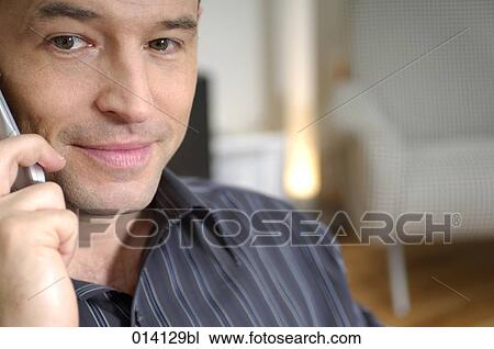 portrait of content young man with mobile phone View Large Photo Image Stock Image - portrait of content young man with mobile phone. Fotosearch