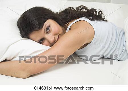 portrait of content young woman lying in bed View Large Photo Image Stock Image - portrait of content young woman lying in bed. Fotosearch