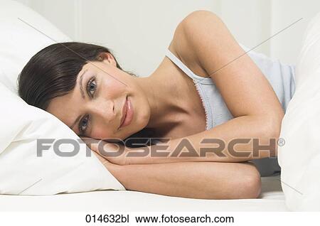 portrait of content young woman lying in bed View Large Photo Image Stock Image - portrait of content young woman lying in bed. Fotosearch