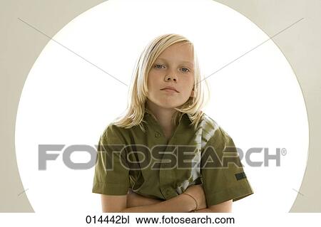 Stock Image - portrait of cross-armed young boy looking at camera. Fotosearch