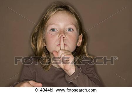 portrait of girl putting finger on mouth View Large Photo Image Stock Image - portrait of girl putting finger on mouth. Fotosearch