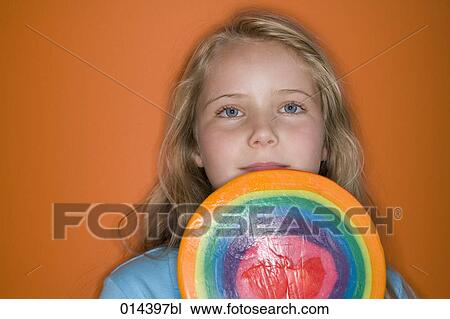 Stock Image - portrait of girl with giant lollipop. Fotosearch