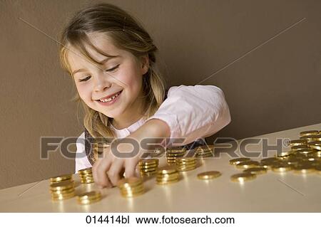 portrait of little girl counting golden coins View Large Photo Image Stock Image - portrait of little girl counting golden coins. Fotosearch