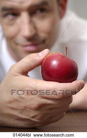 portrait of man looking at red apple View Large Photo Image Stock Image - portrait of man looking at red apple. Fotosearch