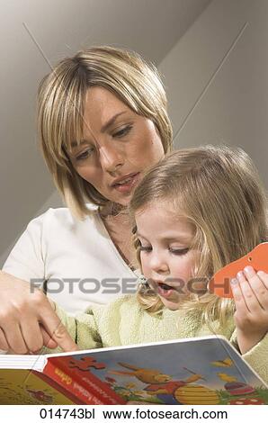 portrait of mother reading picture book together with her little daughter View Large Photo Image Stock Image - portrait of mother reading picture book together with her little daughter. Fotosearch