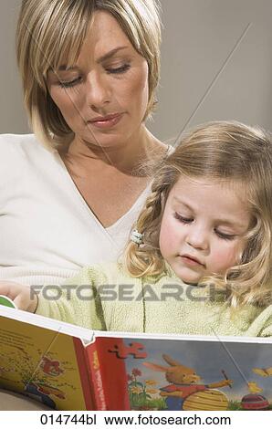 portrait of mother reading picture book together with her little daughter View Large Photo Image Stock Image - portrait of mother reading picture book together with her little daughter. Fotosearch