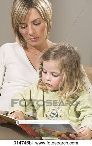 portrait of mother reading picture book together with her little daughter View Large Photo Image Stock Image - portrait of mother reading picture book together with her little daughter. Fotosearch